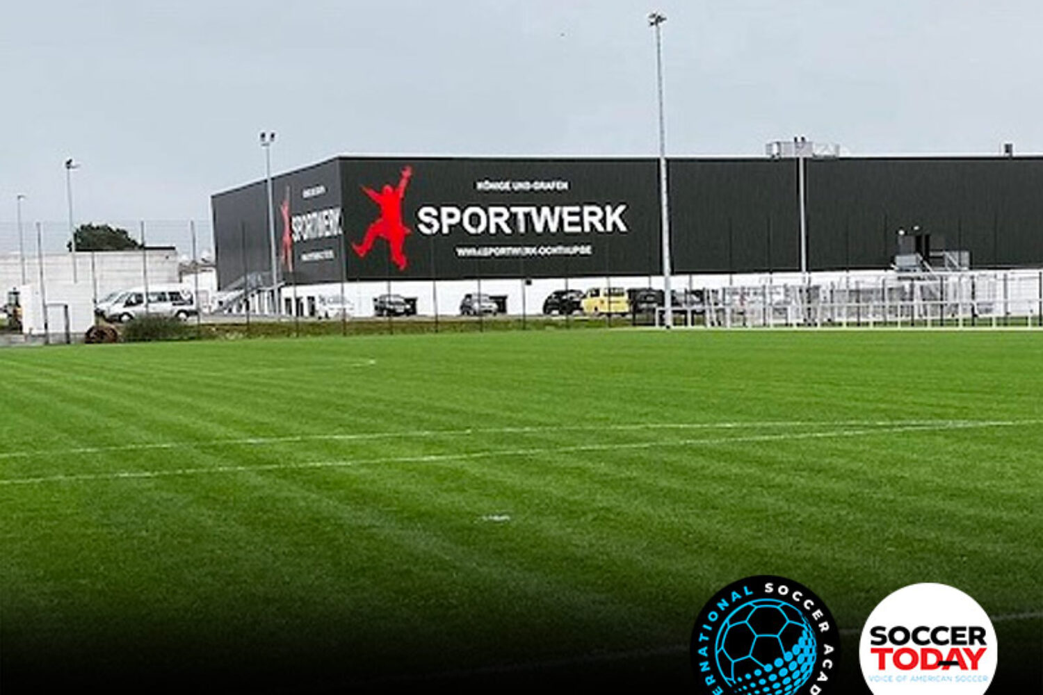A well-maintained soccer field with a Sportwerk building in the background.