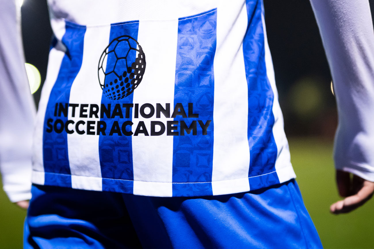 Player wearing a jersey with International Soccer Academy logo.