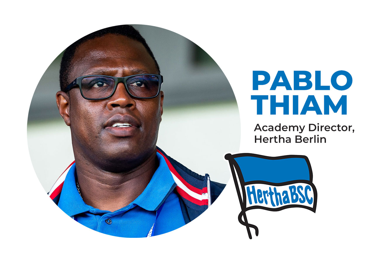 Pablo Thiam, Academy Director of Hertha Berlin, pictured with the club's logo.