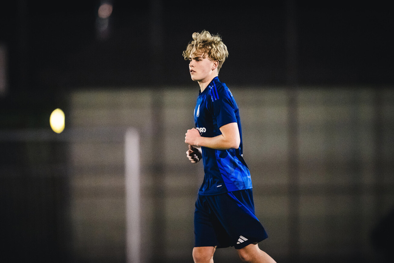 A young soccer player in blue uniform is on the field.