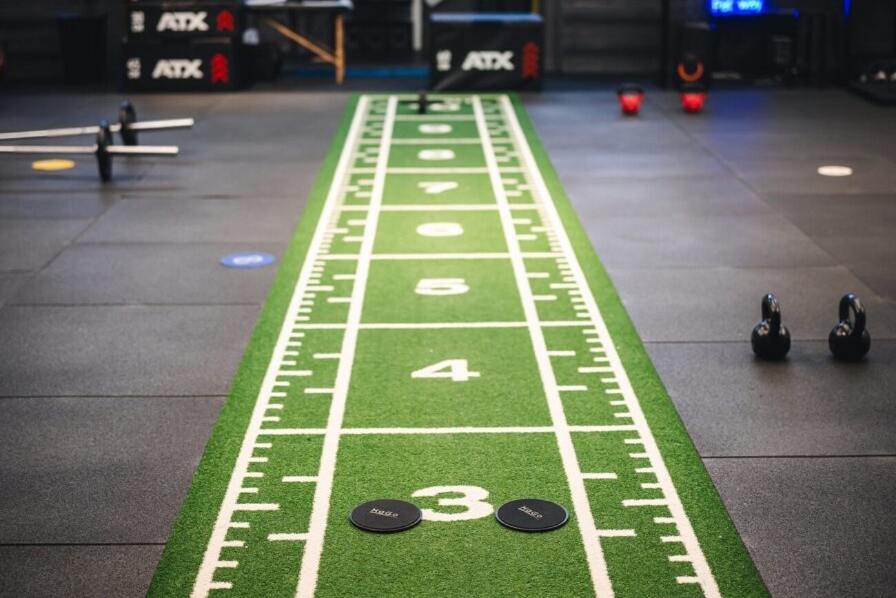 Indoor gym with green numbered track.
